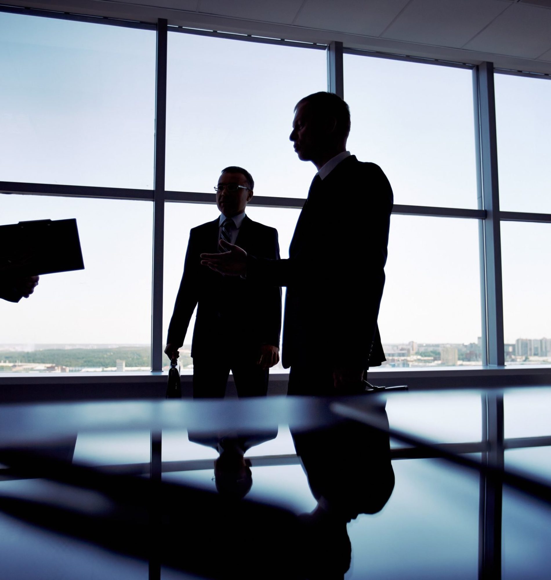 Shady image of a manager discussing business matters with her subordinates